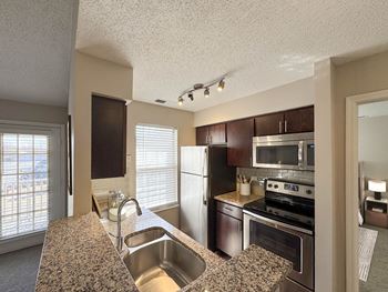 Granite countertop, espresso-colored cabinets*